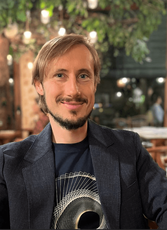 Michael Koval smiling at a café